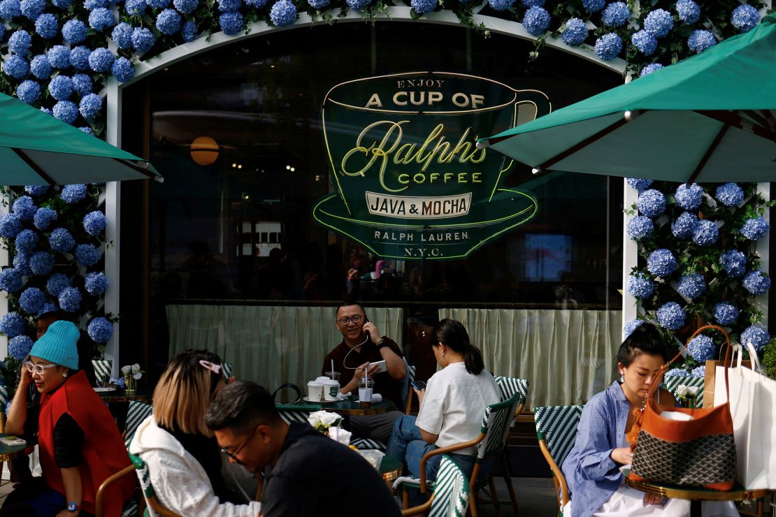 Customers enjoy the outdoor seating area of the café in Beijing.